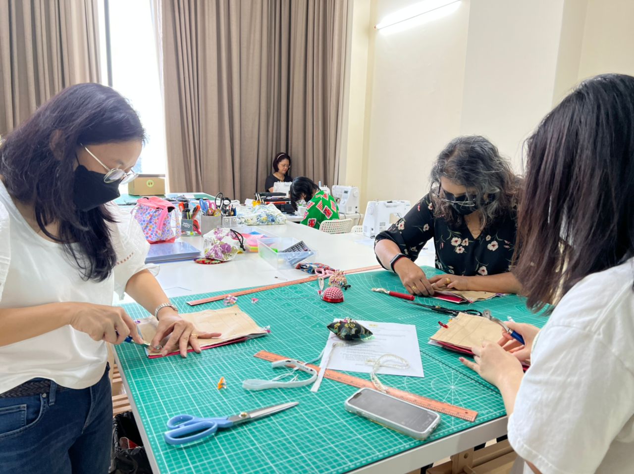 Several students sewing in the Two Moles studio in Subang Jaya
