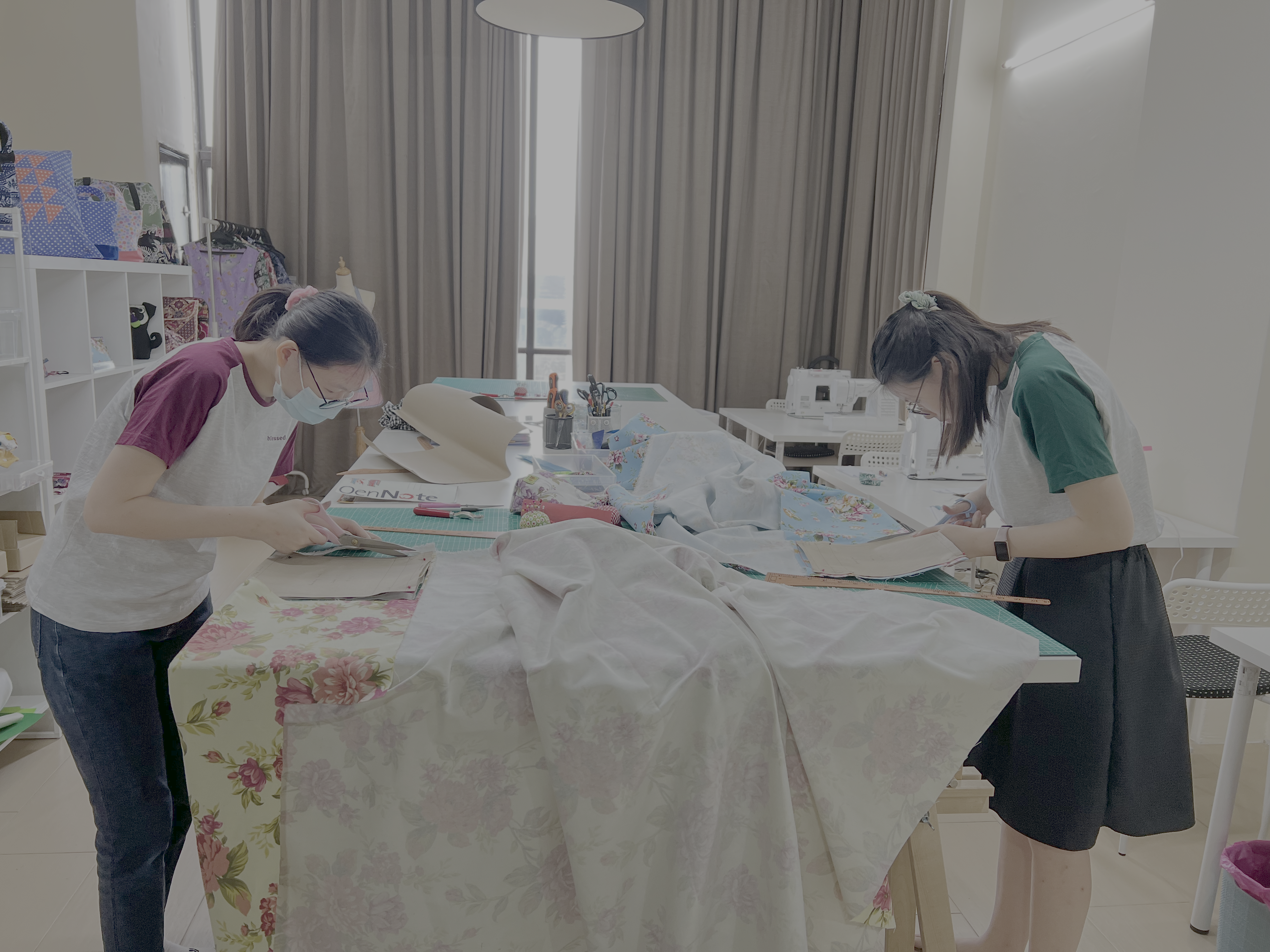 Two students at their sewing machines during a class in the studio